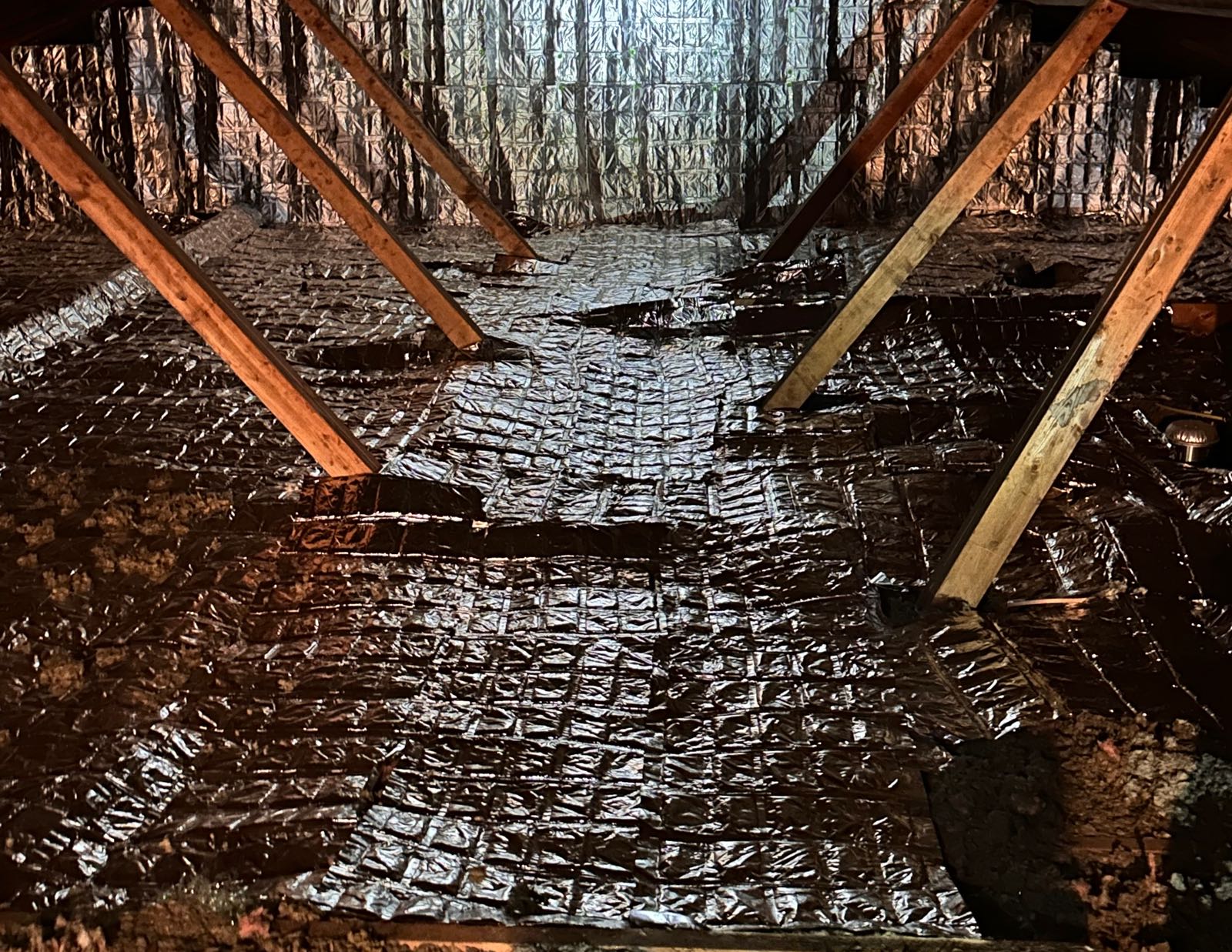 EnigMAT mats laid over the existing insulation of a residential attic