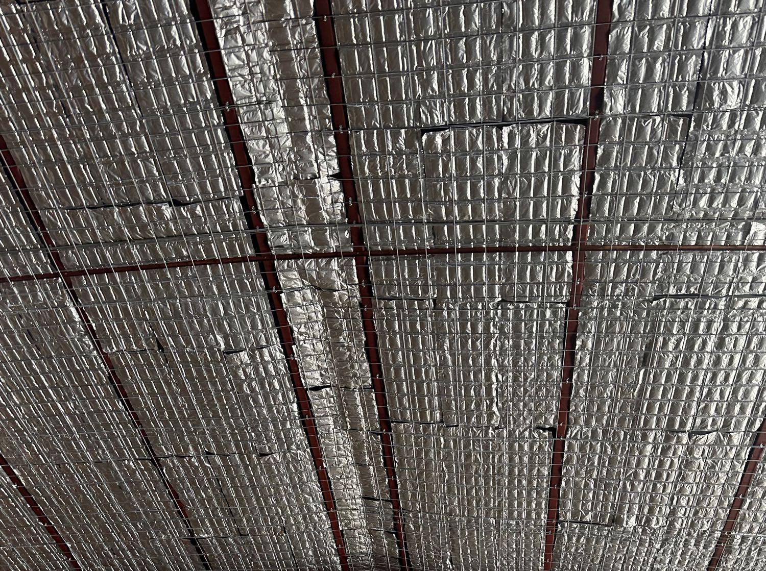 EnigMAT mats on wire mesh under the metal roof of a large building