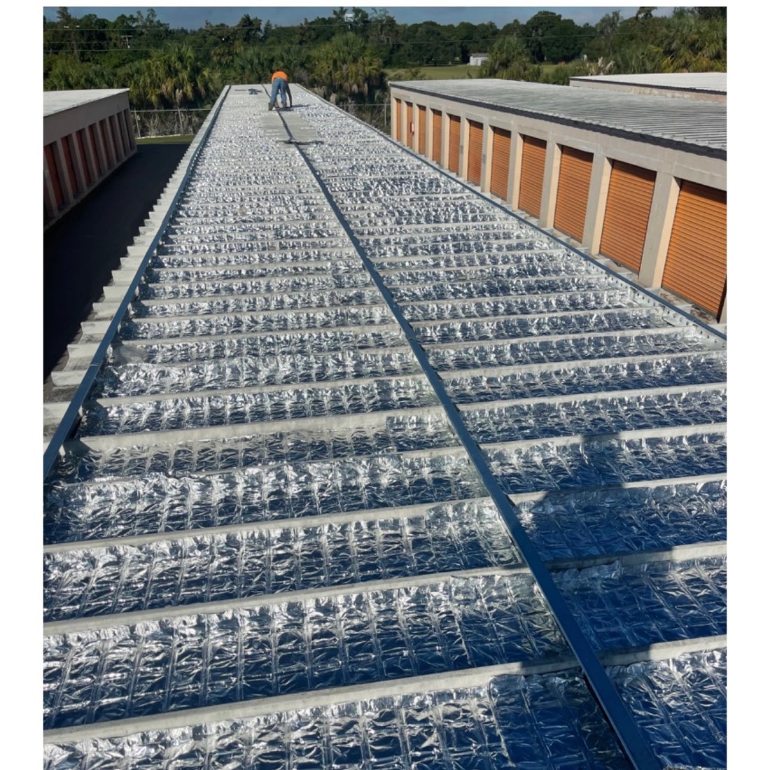 EnigMAT laid across the roof structure of a self-storage building before the new roof